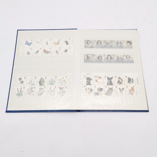 229 - Blue stockbook with UM/M (MNH) collection of GB 250 x 1st class stamps in blocks / strips FV £337.50