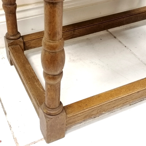 240 - Antique oak 2 drawer side table with stretcher base - has a split to the top but otherwise in good u... 