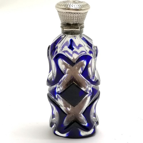 89 - Antique blue overlaid glass scent bottle with unmarked silver lid - 9.5cm ~ dents to lid, lacks stop... 