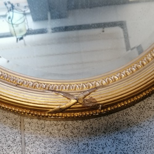 169 - Antique gilded oval mirror with bevelled glass plate - 86cm x 60cm ~ slight losses to gesso finish