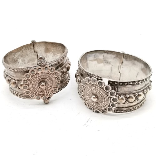 294 - 2 x white metal tribal bangles (largest 6cm across) t/w Civil defence corps badge & crowns inc £5 co... 