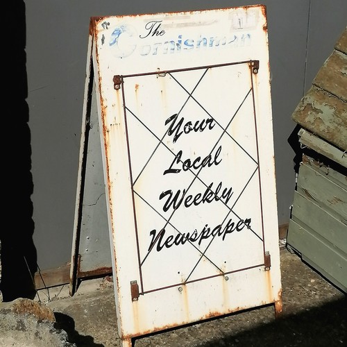 15 - Metal advertising A board 'The Cornishman your local weekly newspaper' 98cm high x 55cm - some wear ... 