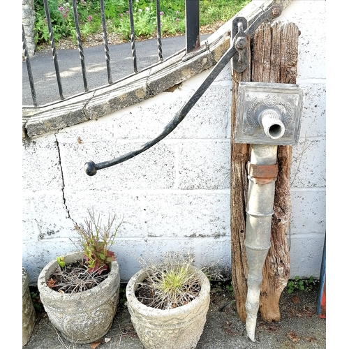 18 - Antique lead pump mounted on a board 122cm high to the top of the handle