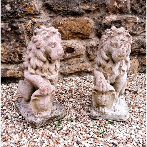 97 - Pair of lion figures holding armorial plaques - 40cm high