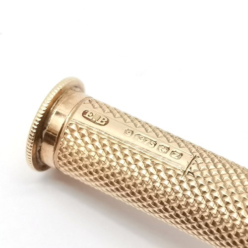 509 - 1949 9ct hallmarked gold engine turned cigar piercer / tamper with sheath & pendant loop by E Baker ... 