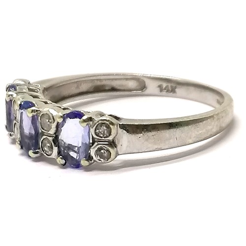 559 - 14ct hallmarked white gold tanzanite (3) & diamond (8) ring - size L & 2.3g total weight