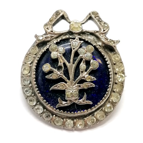 589 - Antique unmarked silver paste white stone set brooch with blue enamel detail of bow & floral design ... 