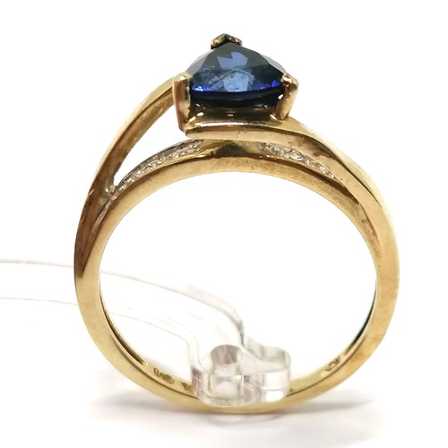 591 - 10ct marked gold ring high set with triangular cut sapphire with diamond set shoulders - size N½ & 2... 