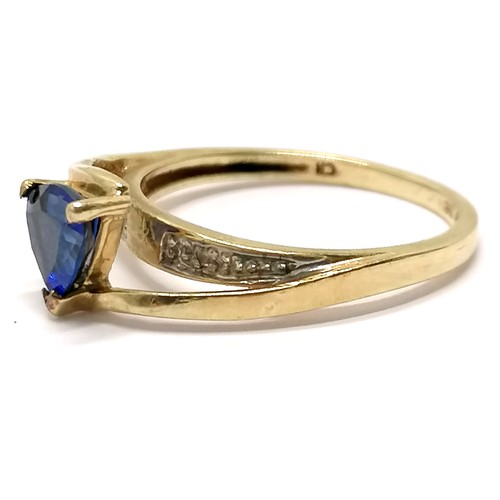 591 - 10ct marked gold ring high set with triangular cut sapphire with diamond set shoulders - size N½ & 2... 