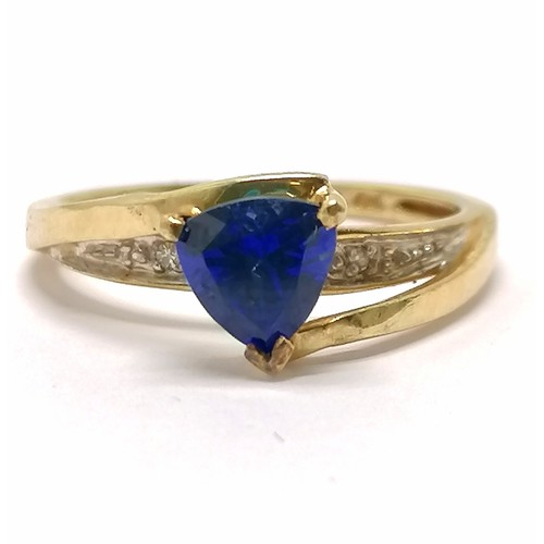 591 - 10ct marked gold ring high set with triangular cut sapphire with diamond set shoulders - size N½ & 2... 