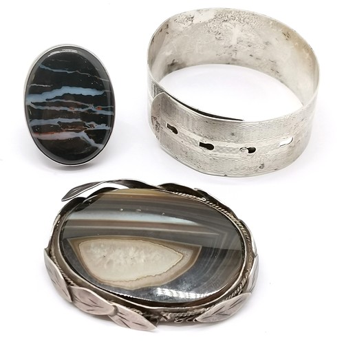 634 - Antique silver buckle adjustable bangle with engine turned detail, silver ring set with agate and an... 