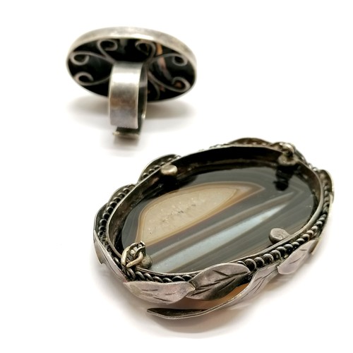 634 - Antique silver buckle adjustable bangle with engine turned detail, silver ring set with agate and an... 