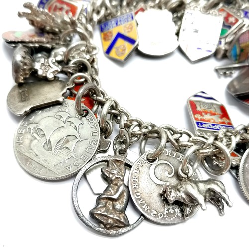 689 - Silver charm bracelet with charms inc 1762 George III 3d, shields, St Christopher etc - total weight... 