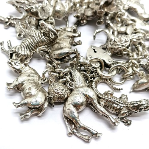 723 - Heavy silver charm bracelet with charms inc mostly African animals / birds + dodo + cobra etc - 234g