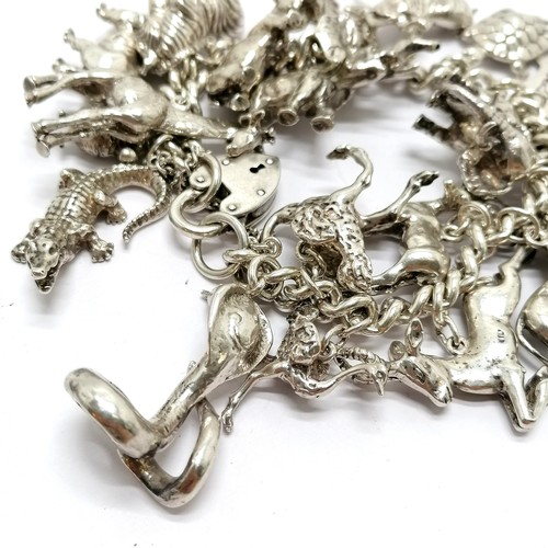 723 - Heavy silver charm bracelet with charms inc mostly African animals / birds + dodo + cobra etc - 234g