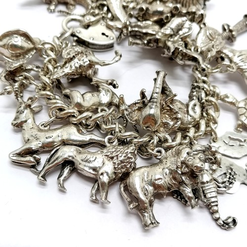 723 - Heavy silver charm bracelet with charms inc mostly African animals / birds + dodo + cobra etc - 234g