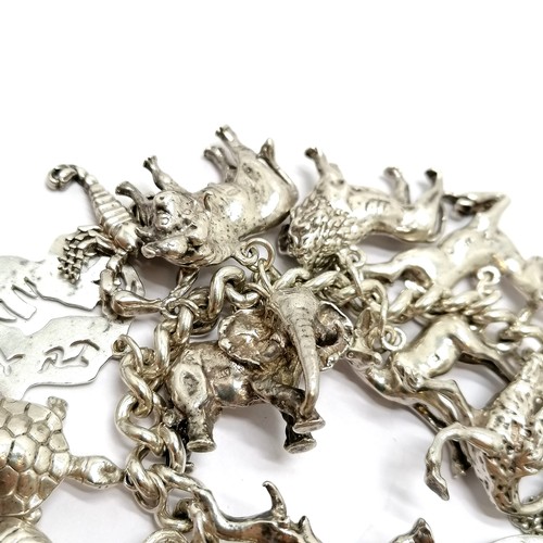 723 - Heavy silver charm bracelet with charms inc mostly African animals / birds + dodo + cobra etc - 234g