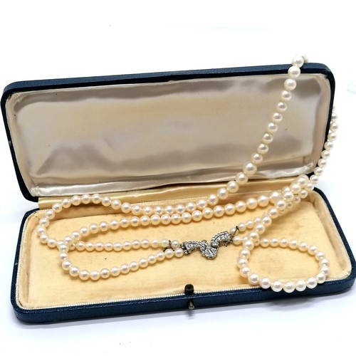 780 - Antique double strand of pearls (40cm) with 9ct marked white gold stone set fancy clasp (2.5cm acros... 