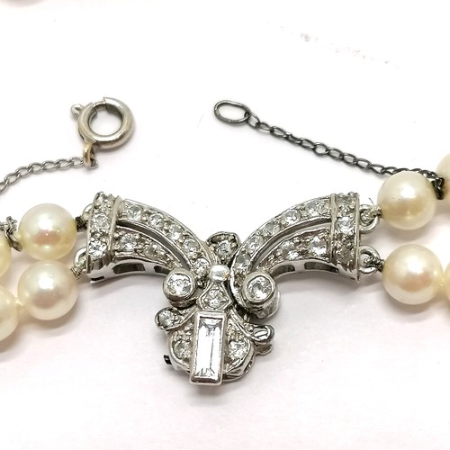 780 - Antique double strand of pearls (40cm) with 9ct marked white gold stone set fancy clasp (2.5cm acros... 