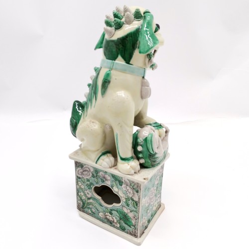 151 - Antique Chinese fo dog (with baby) figure on floral decorated plinth - 31cm high ~ chip to base and ... 