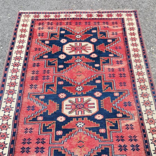 161 - Turkish hand woven wool rug with blue and red geometric design star border - 185cm x 109cm - has sig... 