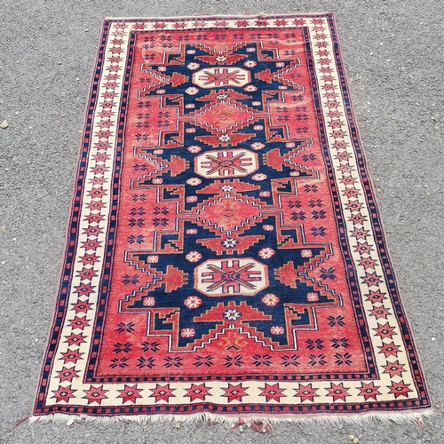 161 - Turkish hand woven wool rug with blue and red geometric design star border - 185cm x 109cm - has sig... 