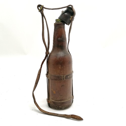 226 - Antique military campaign leather covered bottle with carry handle - 33cm high & missing 1 strap to ... 