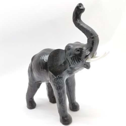 244 - Leather model of an elephant with raised trunk - 46cm high ~ slight crack to trunk