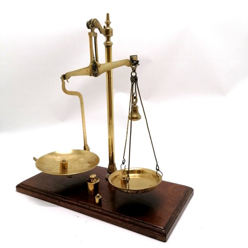 329 - Pair of brass balance scales on an oak base with 4 weights - scales height 43cm x 41cm across x 20cm... 