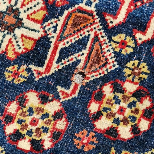 380 - Antique fine wool red grounded rug with blue detailed panels  and a cream central medallion 231cm x ... 