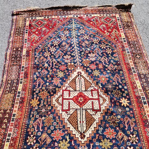 380 - Antique fine wool red grounded rug with blue detailed panels  and a cream central medallion 231cm x ... 