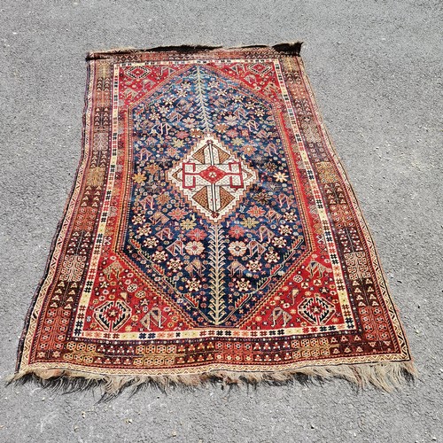 380 - Antique fine wool red grounded rug with blue detailed panels  and a cream central medallion 231cm x ... 