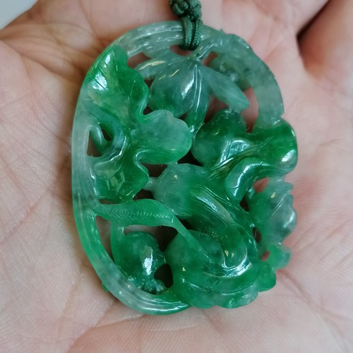 620 - Chinese hand carved green jade pendant with pierced flower / fruit detail with a pink jade bead - pe... 