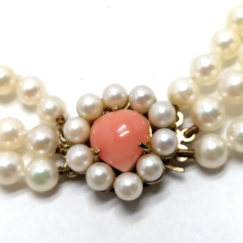 406 - Good quality triple strand of cultured pearls with 9ct hallmarked gold clasp set with coral & pearls... 