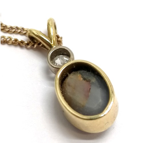 412 - Star sapphire & diamond set 2cm drop pendant in unmarked gold (touch tests as 18ct) on an UnoAErre I... 