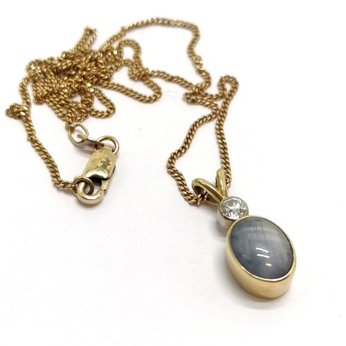 412 - Star sapphire & diamond set 2cm drop pendant in unmarked gold (touch tests as 18ct) on an UnoAErre I... 