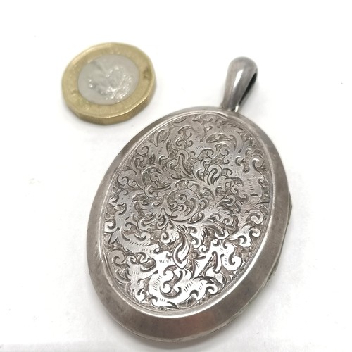 530 - Antique large Victorian unmarked silver locket with engraved detail to front - 6.5cm drop & 20g tota... 