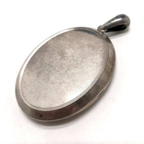 530 - Antique large Victorian unmarked silver locket with engraved detail to front - 6.5cm drop & 20g tota... 