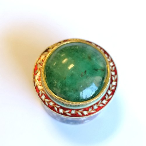 592 - Unmarked high carat gold (touch tests as 22ct) circular lidded box with large cabochon emerald (appr... 