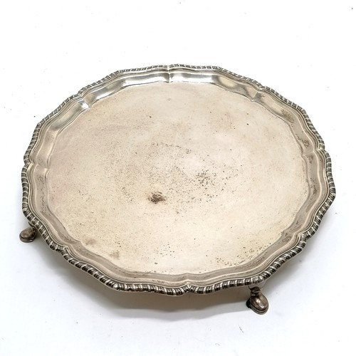 699 - 1929 silver salver with gadrooned wavy edge border on 4 hoof feet - 26.5cm diameter & 571g  ~ slight... 