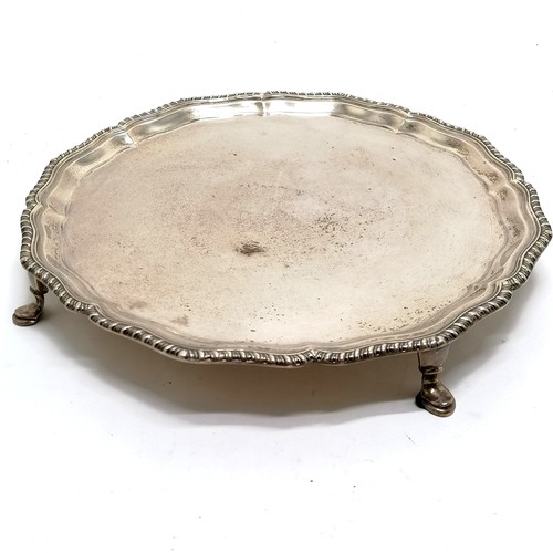 699 - 1929 silver salver with gadrooned wavy edge border on 4 hoof feet - 26.5cm diameter & 571g  ~ slight... 