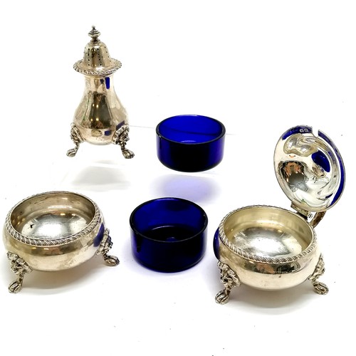 701 - 1939 silver 3 piece cruet with gadrooned cast border and lion mask feet with blue glass liners by A ... 