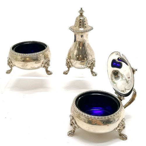 701 - 1939 silver 3 piece cruet with gadrooned cast border and lion mask feet with blue glass liners by A ... 