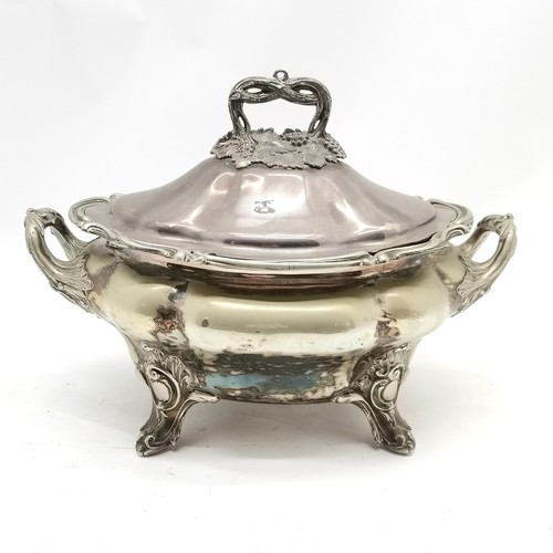 711 - Large EPNS 2 handled lidded tureen in Rococo style on 4 feet with grape detail to handle (28cm high ... 