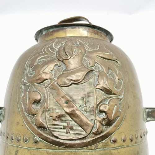 221 - Antique lidded brass riveted coal bin with embossed armorial detail 46cm high has some dents and a s... 