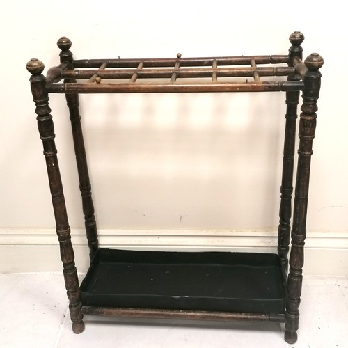 239 - Antique turned wooden stick stand with metal tray 60cm x 26cm x 76cm high -  has losses to the varni... 