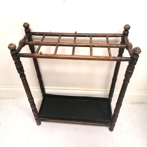 239 - Antique turned wooden stick stand with metal tray 60cm x 26cm x 76cm high -  has losses to the varni... 