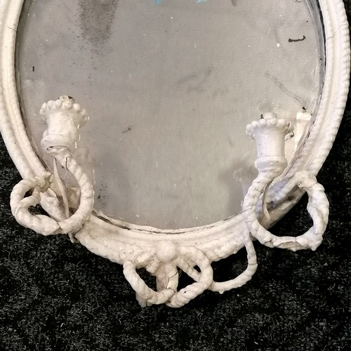 254 - Antique oval plaster framed mirror with bow and sconce detail ( have been wired for lights but would... 