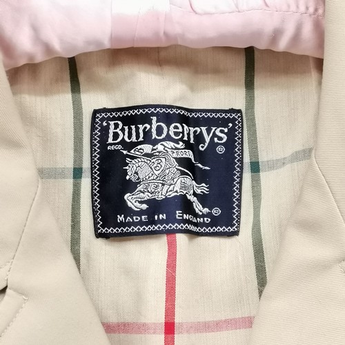 324 - Burberry's ladies rain coat 56cm pit to pit x 100cm long - Has some marks