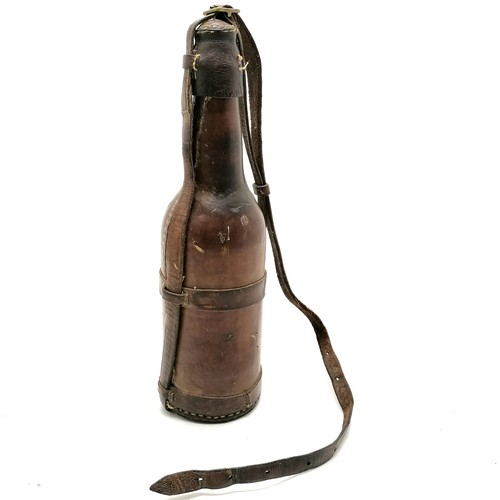 359 - Antique military campaign leather covered bottle with carry handle - 33cm high & missing 1 strap to ... 